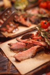 Roast beef with tomatoes and spices on the boards