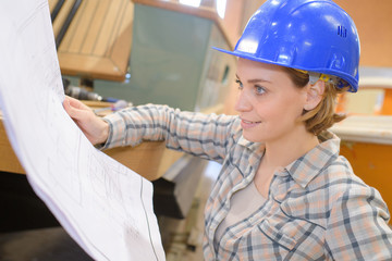 architect woman with helmet and plans