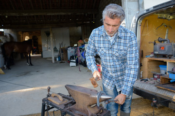 Blacksmith shaping horseshoe