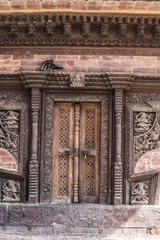 wooden traditional handcrafted door in the brick wall