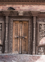 wooden traditional handcrafted door in the brick wall
