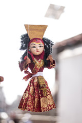 local crafts and souvenir of beautiful traditional puppets hanging for sale in Nepal