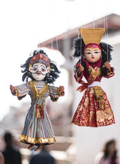 local crafts and souvenir of beautiful traditional puppets hanging for sale in Nepal