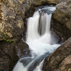 Fototapeta na wymiar Close up mountain waterfall fast rushing water.