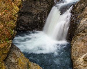 Close up mountain waterfall fast rushing water.