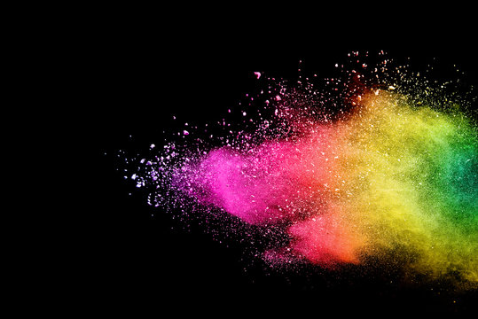 Freeze motion of colored powder explosions isolated on black background