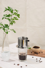 Coffee dripping in vietnamese style on wooden table
