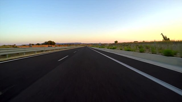 pov of a country road at sunset