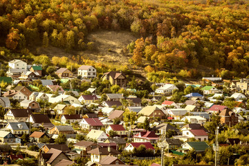 A small settlement on a hillside in the autumn season on a sunny day.