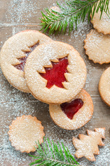 Christmas baking. Homemade cookies with strawberry jam in the form of Christmas trees on a wooden background. Christmas food. New Year card. Rustic style.