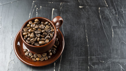 Mug with coffee beans on a dark background