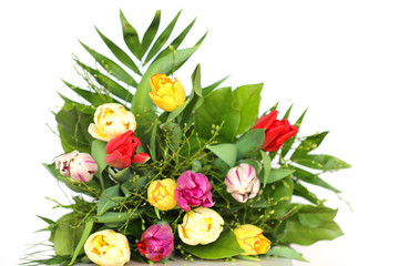 Flower tulip. Bouquet of multicolored tulips with green leaves on a white background