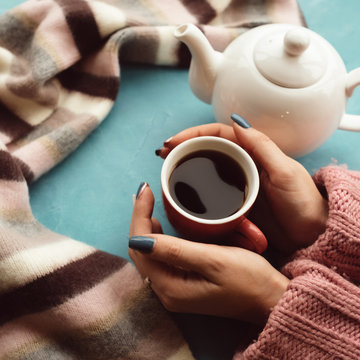 warm and comfy concept. Woman drinks hot tea on a cold autumn day to treat cold or flu