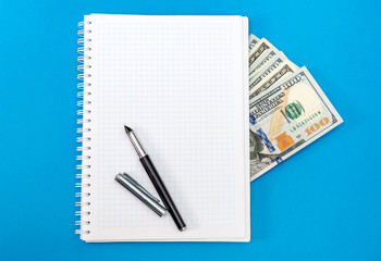 Blank notepad with money and pen. Business concept.
