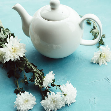 Herbal tea and chrysanthemums on a blue background. Healthcare lifestyle. Pure and tenderness.