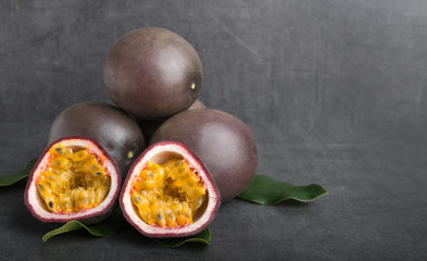 passion fruit on a grey stone table front view