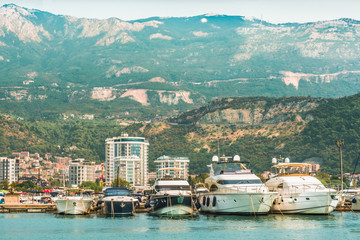 Marina for sailing yachts and boats with a view of the city of Budva and the Balkan Mountains,...