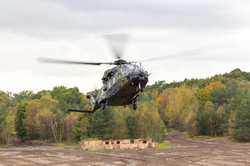 german military helicopter in flights over battlefield