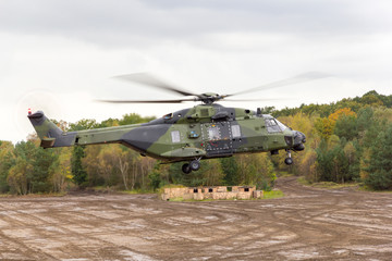 german military helicopter in flights over battlefield