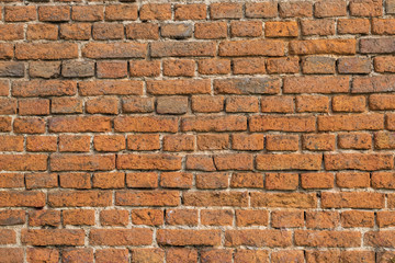 Naklejka premium Old brick wall texture. Vintage construction, surface build from old orange and brown bricks.