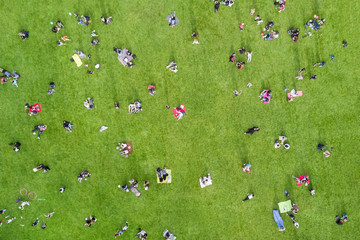 View from the height of the many people are resting on the lawn in the park