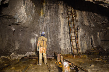 Underground abandoned ore mine shaft tunnel gallery miner with the stairs ladder