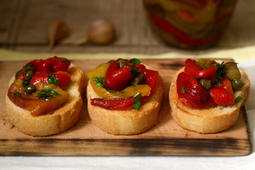 Fresh and tasty bruschetta with pickled bell pepper, capers and parsley.