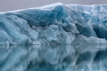 Fototapeta na wymiar Iceberg Reflecting in The Water
