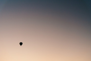 Hot air balloon flying over rock landscape at Cappadocia Turkey