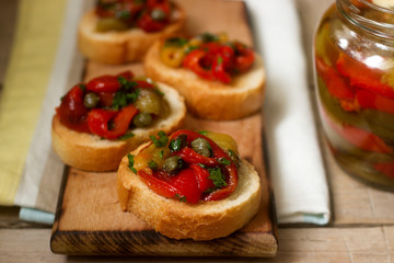 Fresh and tasty bruschetta with pickled bell pepper, capers and parsley.