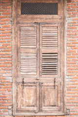 Old wooden door on brick wall.