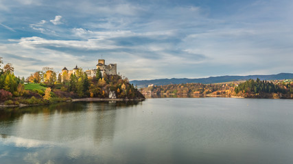 Fototapeta premium Stunning castle by the lake at dusk in autumn