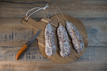 French salami Sausage on a wooden table