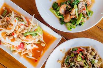 stir-fried pork and herb with rice, Stir fried kale and crispy pork with rice, papaya salad or Som Tum, Thai food