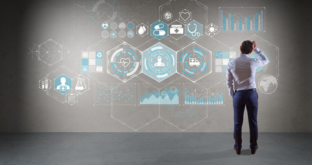 Businessman watching medical interface on a wall 3D rendering