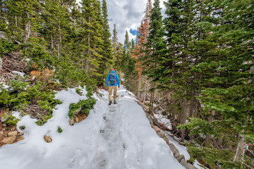 Tourist with backpack hiking on snowy trail © haveseen