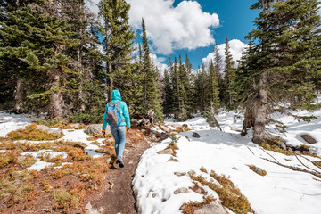 Obraz premium Tourist with backpack hiking on snowy trail