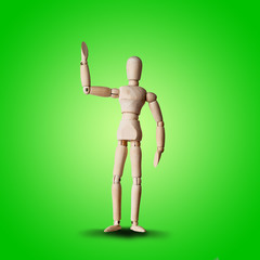 Wooden Mannequin friendly wave hand with greeting on green background