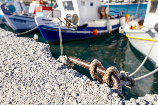 Fishing boats are tied with rope for the pier, wharf close-up at marina