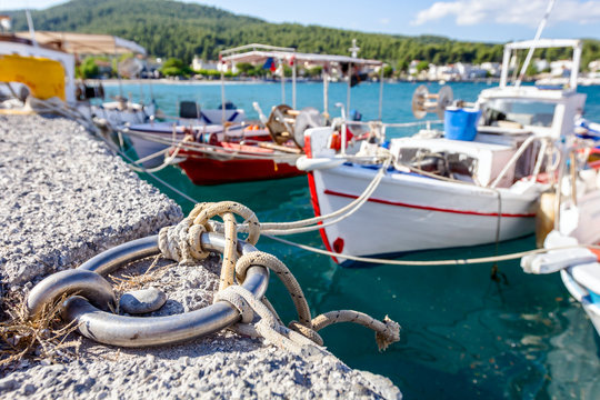 Fototapeta Fishing boats are tied with rope for the pier, wharf close-up at marina