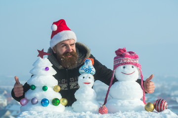 Santa man winking with snowy sculptures