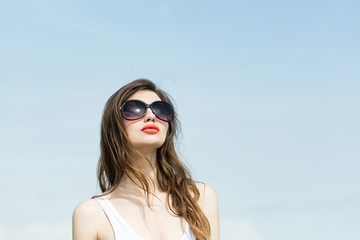 Girl in white swimsuit and glasses