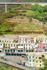 Fototapeta premium View to city buildings and mountains in a foggy day. Riomaggiore, Italy