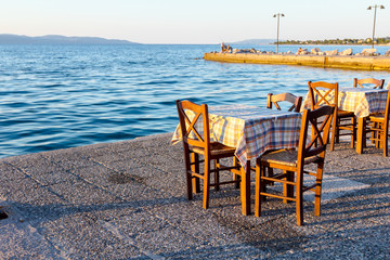 Fototapeta na wymiar Evening at traditional Greek tavern, restaurant by the open sea