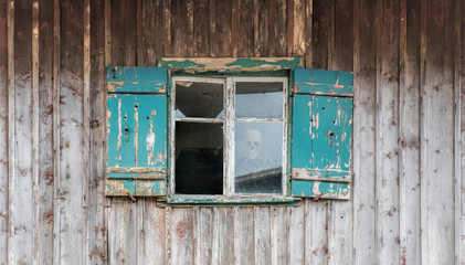 skreleton behind the window