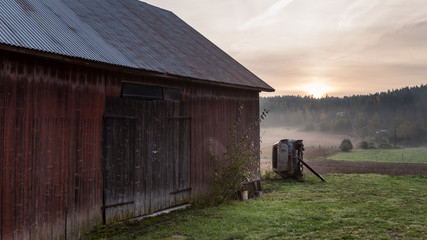 Morning landscape of barn and abandoned  rusty car. © tommitt