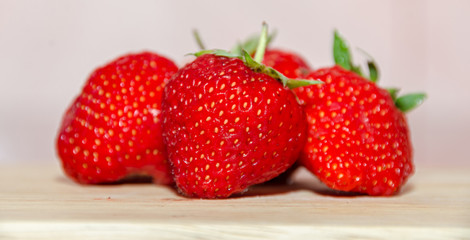 Red strawberries fruits, rustic wood background, close up