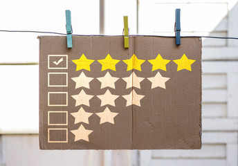 rating survey painting on cardboard and checking five star 
