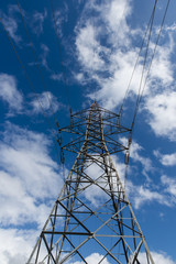 High voltage pole, clouds, blue sky