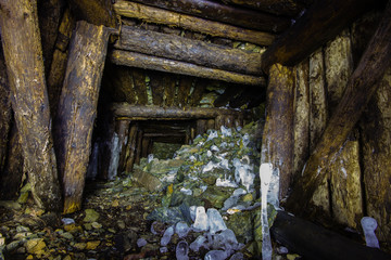 Fototapeta na wymiar Abandoned old chromite mine shaft tunnel with wooden timbering